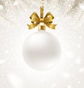 Hanging white Christmas bauble with glitter golden ribbon on a winter snow background. Christmas ball with copy space for your gre Royalty Free Stock Photo